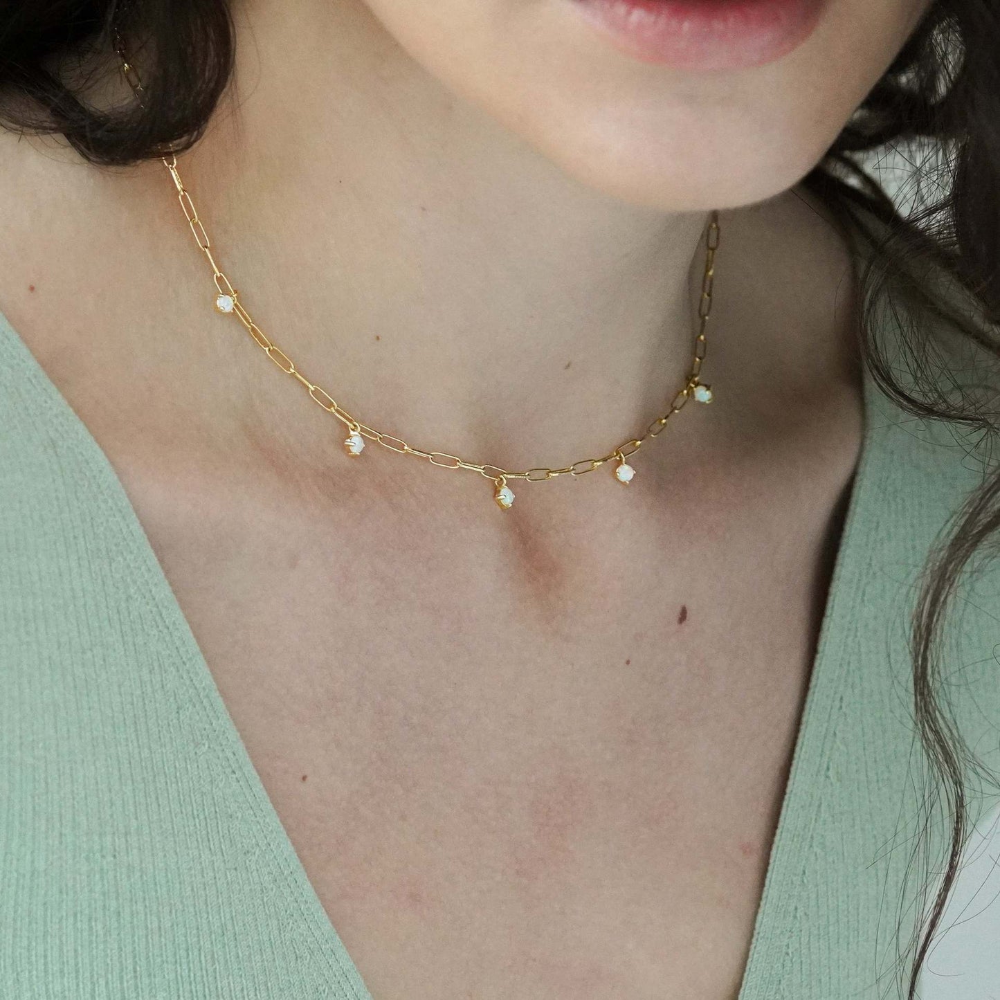 Flat lay of fringed turquoise necklace with geometric pendant design