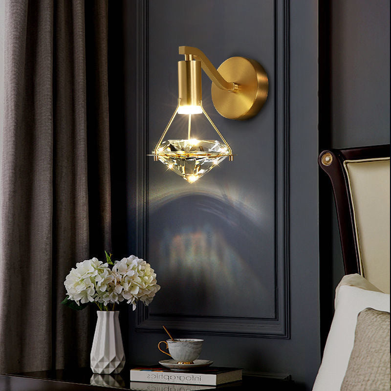 Elegant diamond crystal wall lamp illuminating a living room.