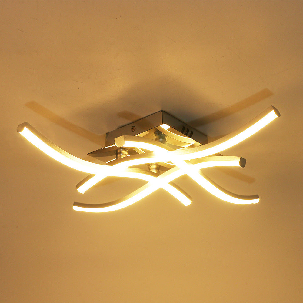 Sleek ceiling lamp providing soft lighting in a minimalist living room.