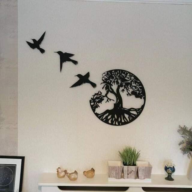 Minimalist iron wall art of birds in flight.