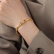 Gold-plated titanium steel diamond bracelet on female model wrist, luxury minimalist jewelry for women