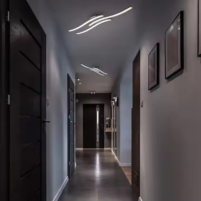 Multiple modern ceiling lamps in a hallway.