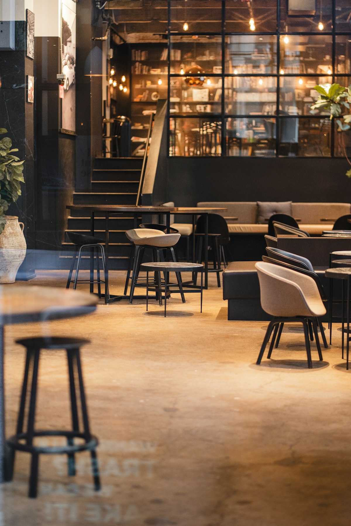 Cafe seating area with warm lighting and mixed chairs