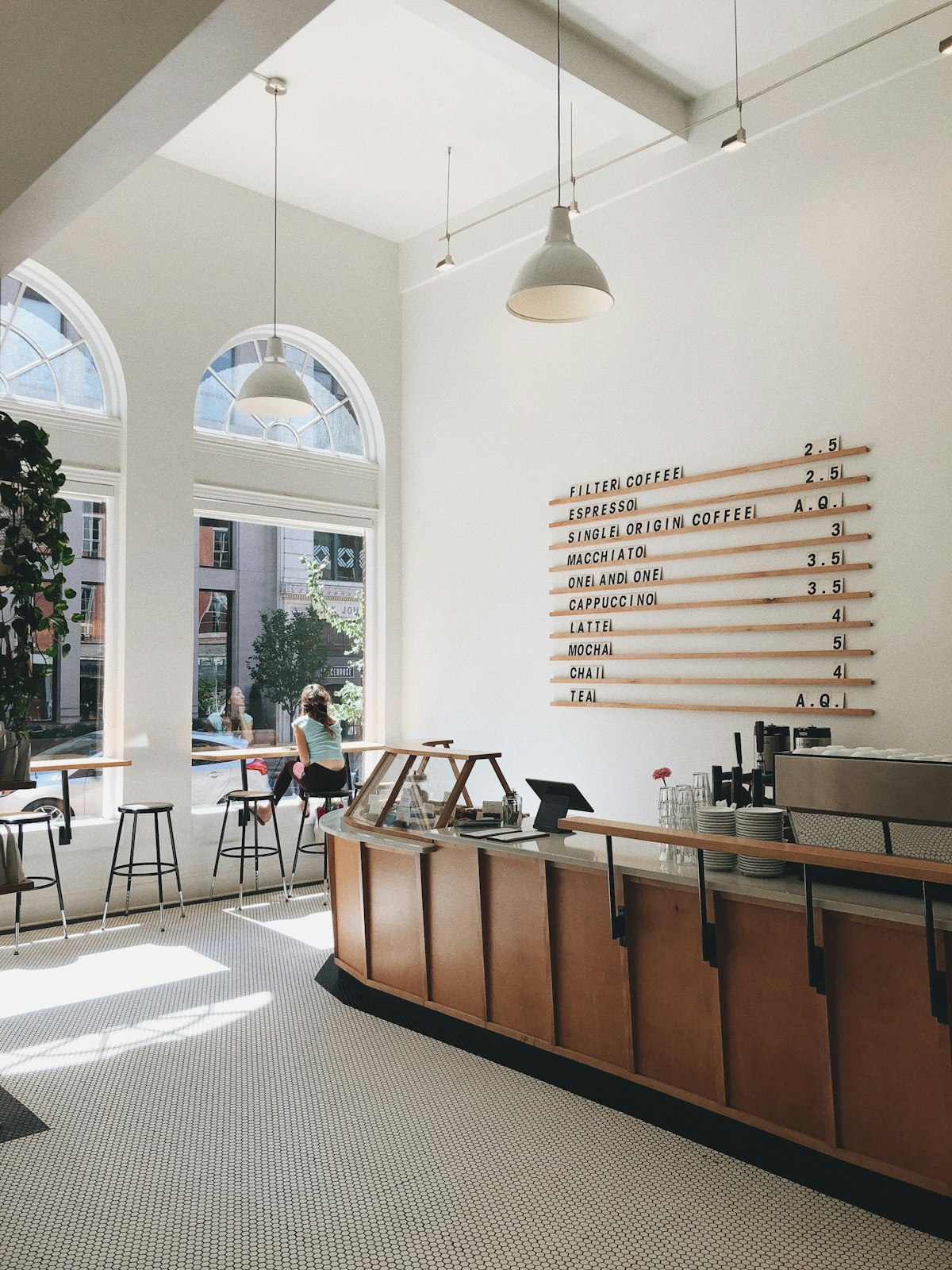 Coffee shop interior with a curved counter and pendant lights