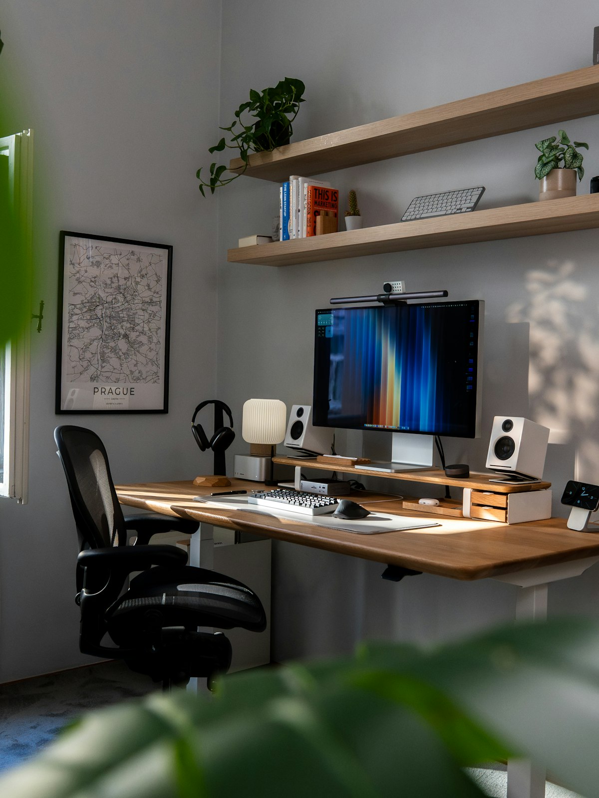 Compact home office desk setup with a computer and plants
