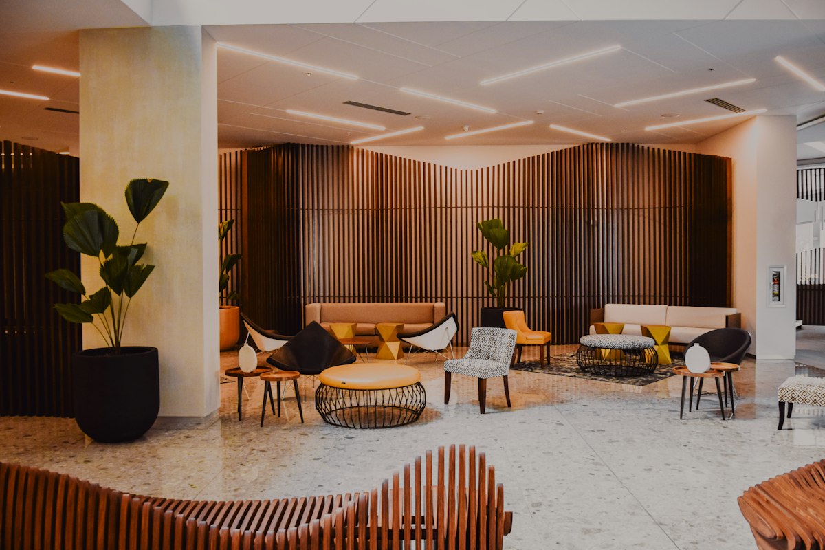 Hospitality lounge with timber wall panels and sculptural designer seating