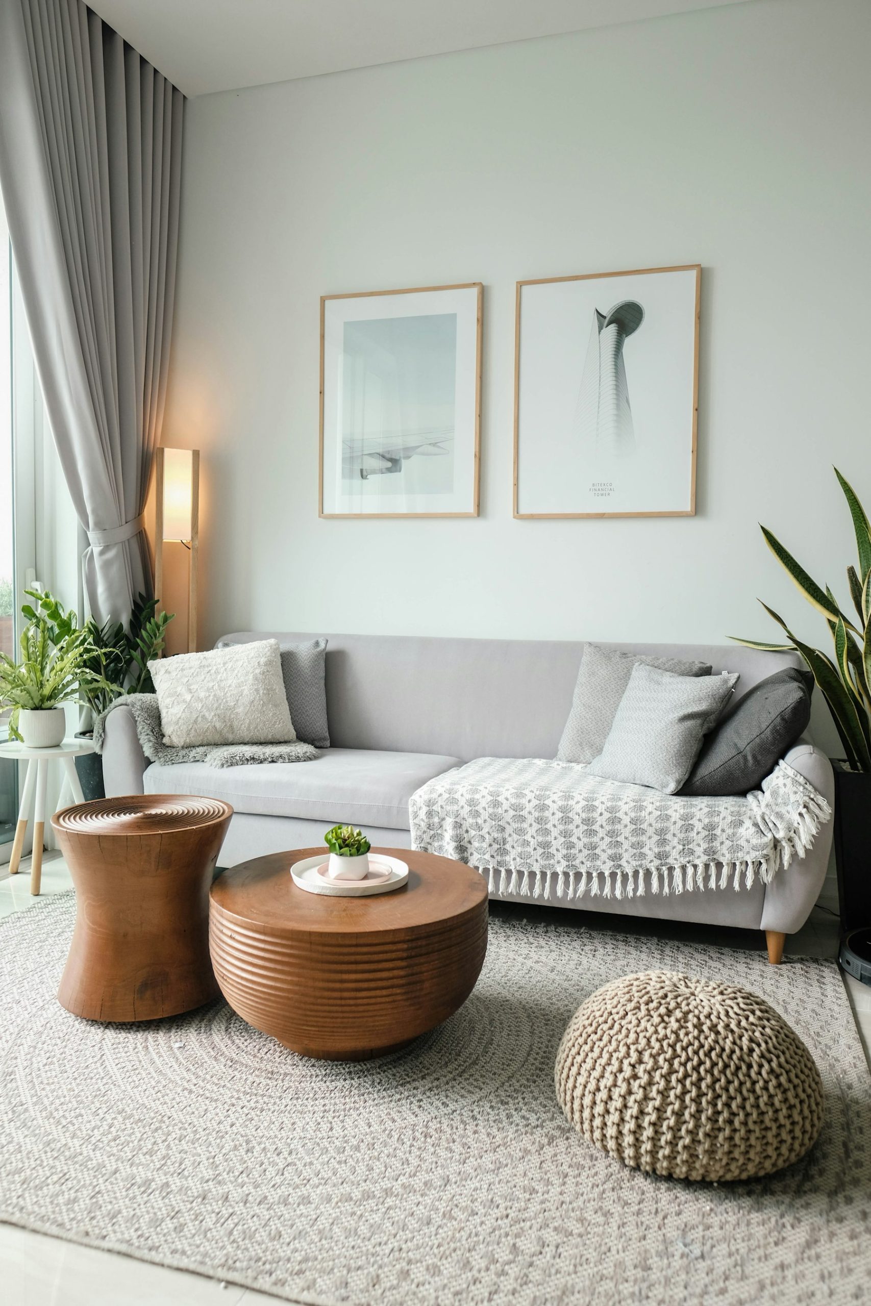 Living room furnished with soft seating in front of a large window
