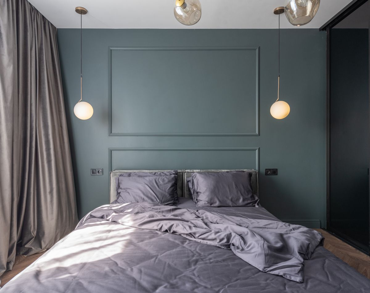 Modern bedroom with soft lighting and layered bedding