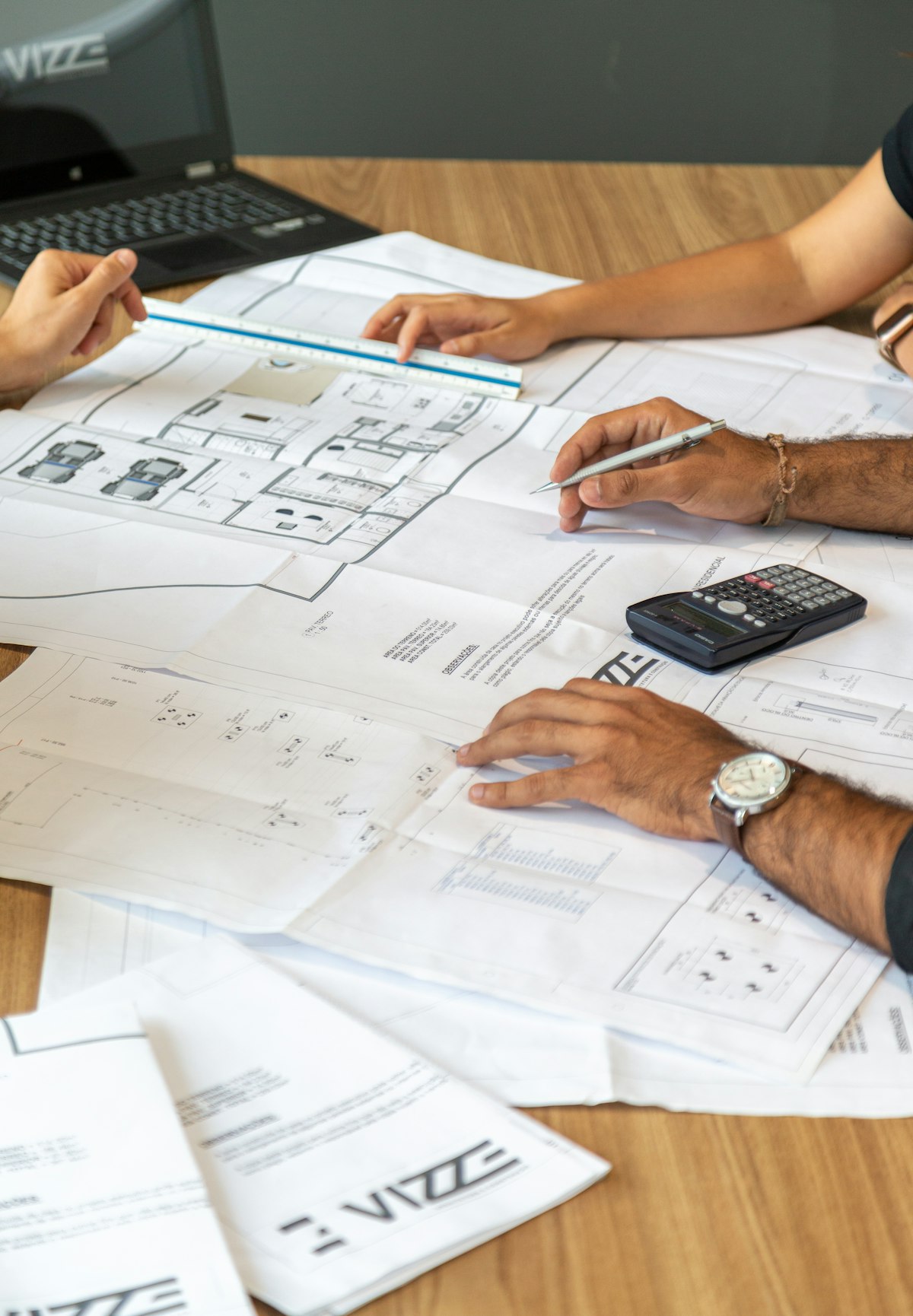 Team reviewing printed layout plans on a desk