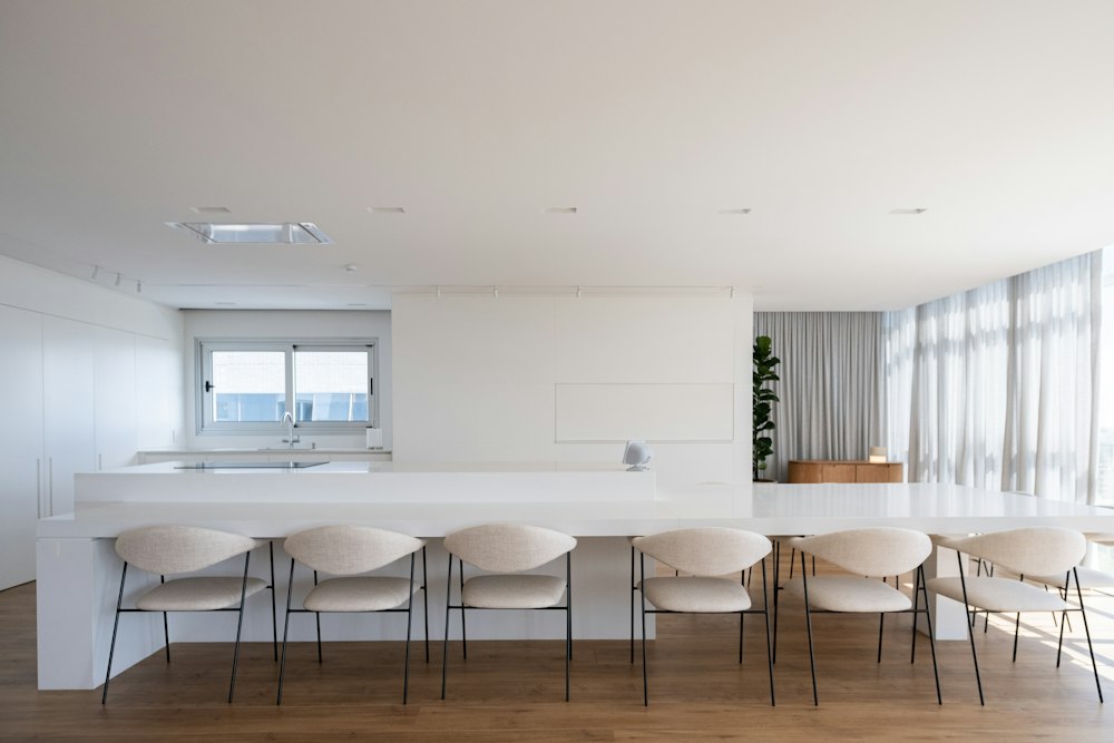 White kitchen island lined with modern stools
